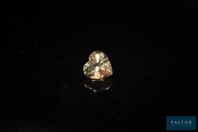 a yellow diamond on a black surface