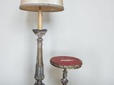 a lamp that is next to a table with a lamp on it