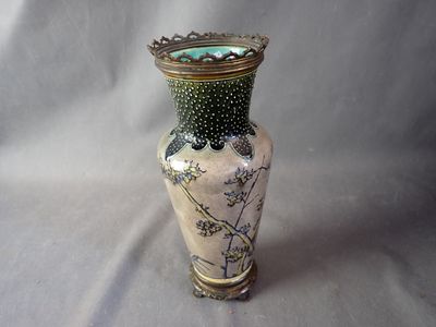 a vase that is sitting on a table with a white background