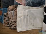 many different types of clothes and a teddy bear on the floor