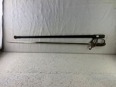 a sword that is laying on the floor in front of a curtain