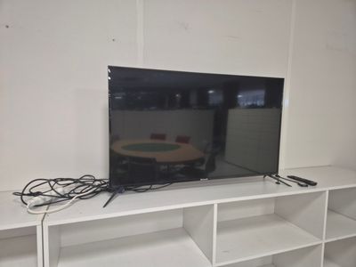 a flat screen tv sitting on top of a white entertainment center