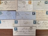 several old envelopes are sitting on a wooden table
