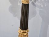 a black and gold vase on a wooden table