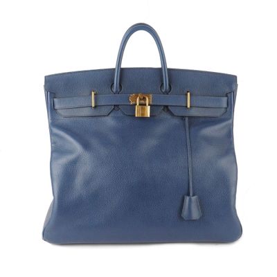 a blue leather handbag with a gold lock on the handle