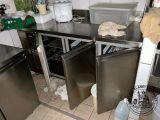 a kitchen with a stainless steel counter top and two refrigerators