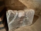 a stack of boxes wrapped in plastic sitting on the floor