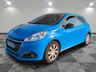 a blue car is parked in a room with a checkered floor