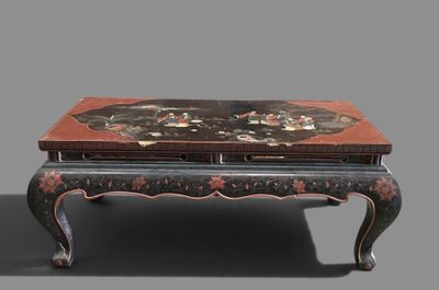 a black and red table with a flower design on it