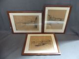 three framed drawings of boats and buildings on display in a wooden frame