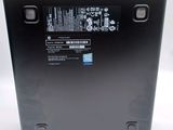 the back of a laptop with a black cover and a blue sticker on it