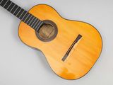an image of a guitar with a wooden body and a black fret