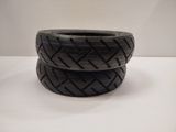 two black tires stacked on top of each other on a table