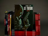 a stack of books with a picture of a man holding a gun