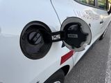 a close up of an electric car charging on the street