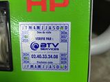 a green vending machine with a red and white sticker on it