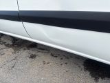 a white car with black stripes parked in a parking lot