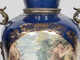 a large blue vase with a painting on it