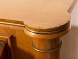 a close up of a wooden desk with a drawer underneath it