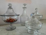 three glass containers with nuts in them sitting on a table