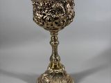 an antique silver plated cup on a stand on a white background