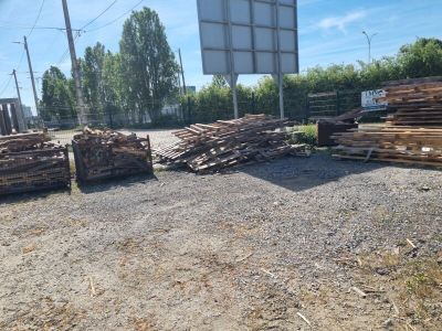 a pile of wood sitting on the ground in front of a basketball court
