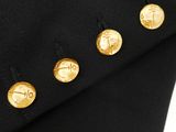 a close up of a black suit with gold buttons on it