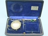 a small silver object in a case on a blue surface