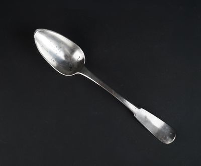 a spoon that is sitting on a black surface