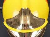 a close up of a fireman ' s helmet on a black background