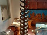 a tall vase that is sitting on a table in a room