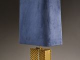 a gold and blue lamp with a blue shade on top of it