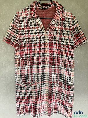 a red and black checkered shirt hanging on a hanger