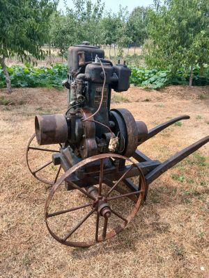 an old tractor that is sitting in the grass