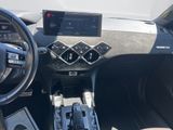 the interior of a car with a steering wheel, dashboard, and dashboard controls