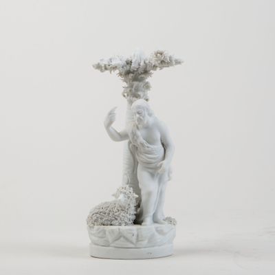 a statue of a man holding a plant in his hand