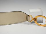 beige leather belt with a gold buckle on a white surface