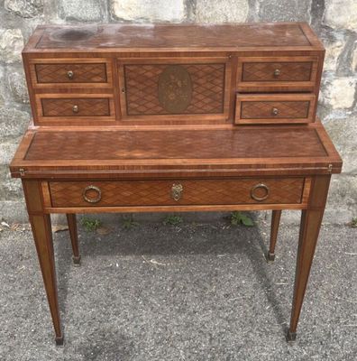 a wooden desk with drawers and drawers on top of it