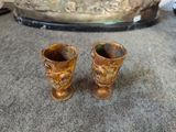 two vases that are sitting on the floor
