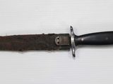 a knife that is laying on top of a piece of paper