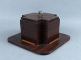 a small wooden box with a key on top of it