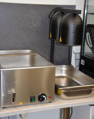 a small kitchen with a stove, sink, and microwave