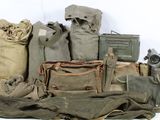 many bags of military items sitting on a white surface