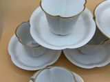 a lot of cups and saucers sitting on a table