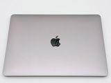 an apple laptop computer sitting on top of a white table