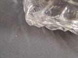 a clear glass vase sitting on a black surface