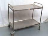 a stainless steel cart with wheels on the floor
