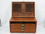 an old wooden chest with two drawers on top of it