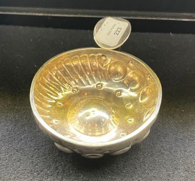 a small glass bowl with a coin in it