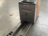 an image of a forklift in a warehouse with a large window in the background